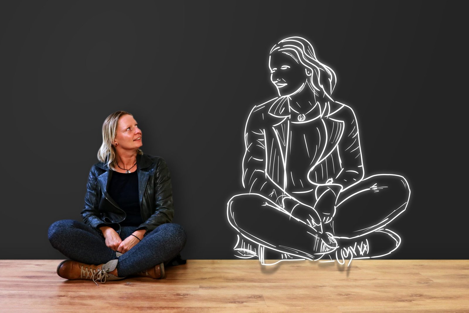 A woman looking at her bigger-sized image on a blackboard as a way to boost her confidence