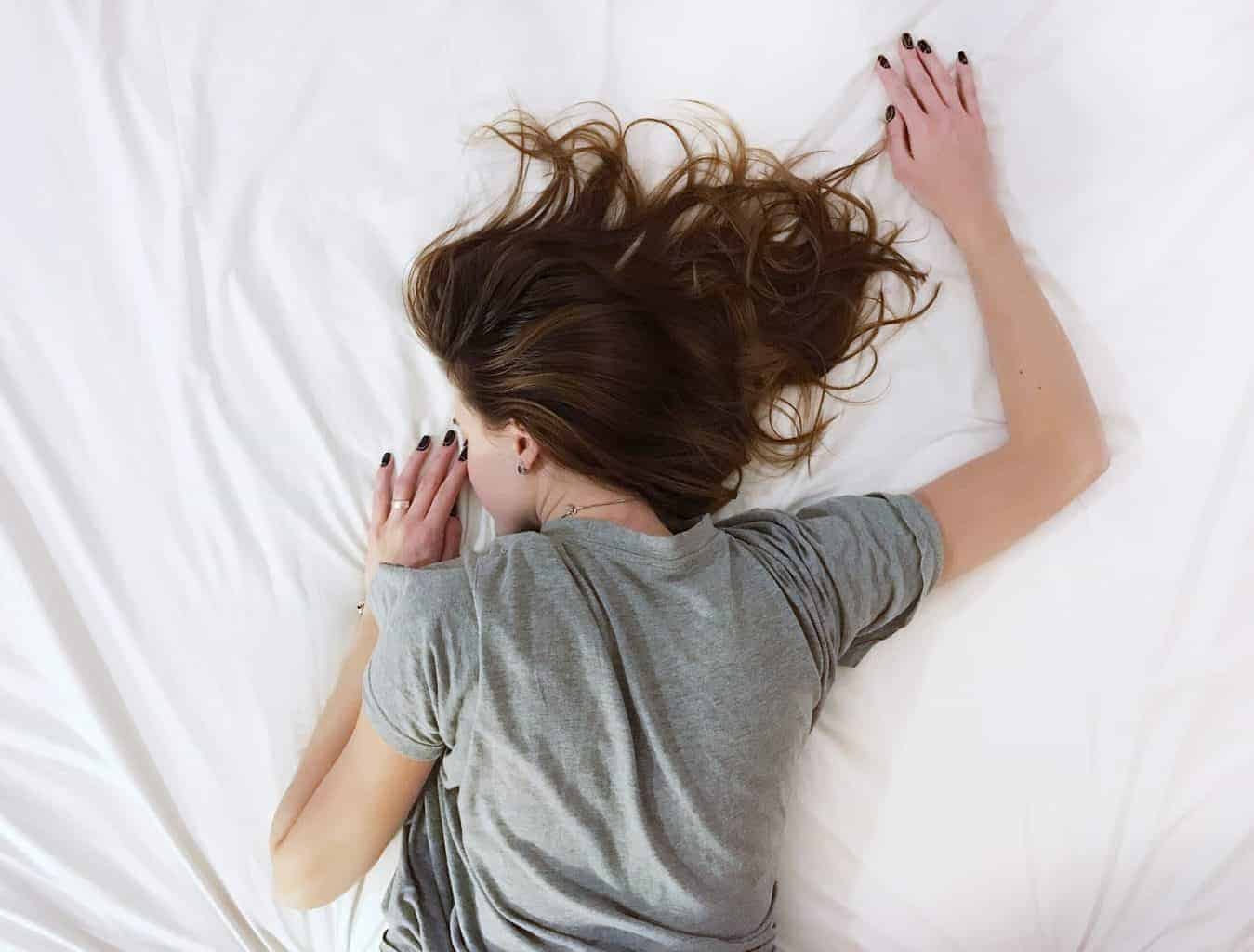 A lady in deep sleep while lying in bed.