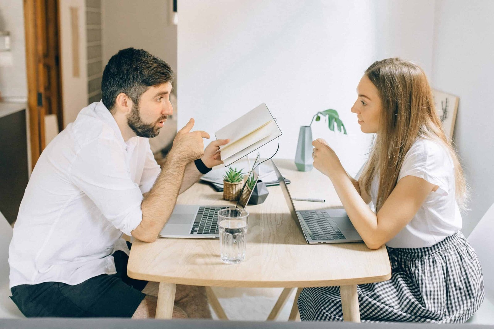 How to achieve effective communication in your marriage now 1 A young couple effectively communicates in their home office, with the wife listening intently while the husband reviews their weekly budget.