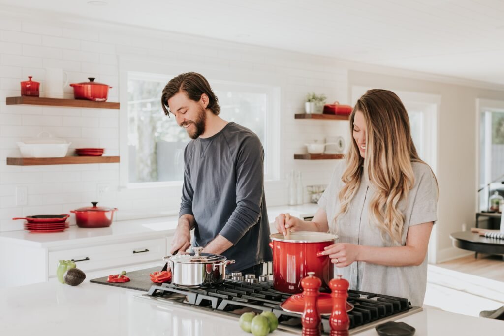 Friendship in Marriage: How to cherish your partner the best 1 A young couple who are cooking together in their kitchen smiling about their friendship in marriage