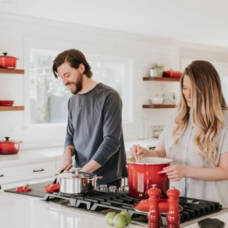 Friendship in Marriage: How to cherish your partner the best 1 A young couple who are cooking together in their kitchen smiling about their friendship in marriage