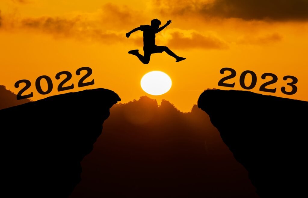 New-Year resolutions: 7 smart ways to perfect it now 4 A man leaping across two hills from 2022 to 2023 with a background of fully lit moonlight