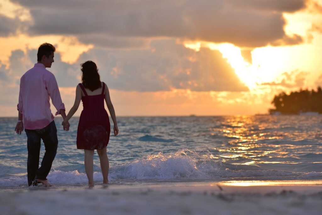 A couple holding hands with a background of a sunset as sign of their loyalty in marriage