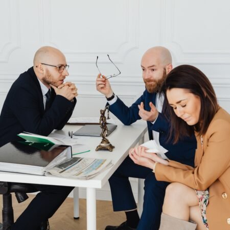 A lawyer consulting with a couple going through breakdown of marriage.