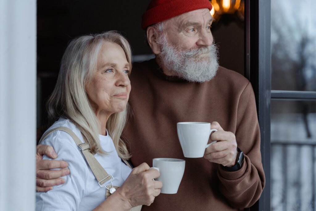 Commitment in marriage: Key to a strong relationship now 3 Older couple drinking coffee happily gazing into the future with joy.