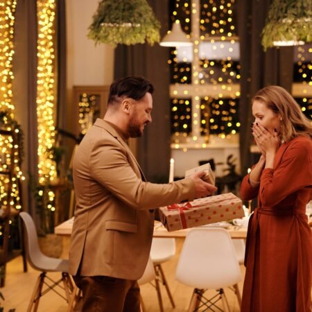 A couple exchanging gifts after a romantic dinner looking as a way to reignite the spark in their marriage