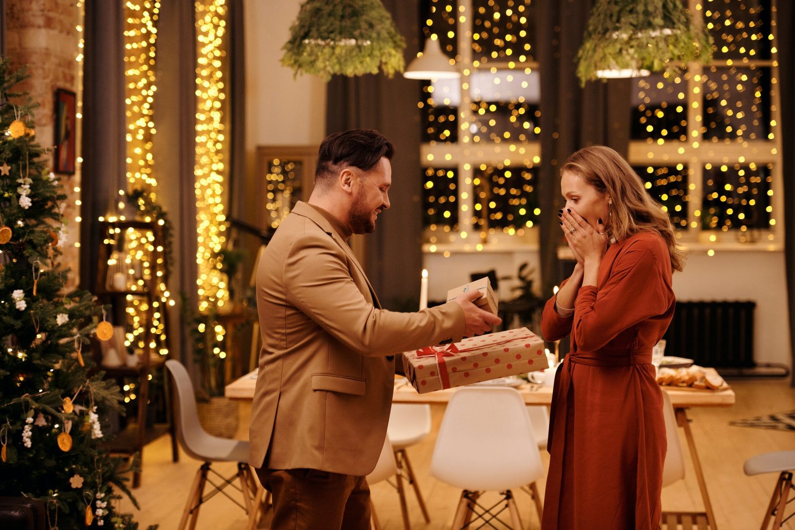 A couple exchanging gifts after a romantic dinner looking as a way to reignite the spark in their marriage