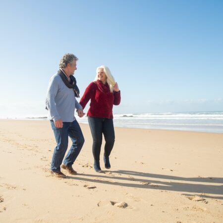 A couple strolling along the beach holding hands as a reflection of healthy boundaries in marriage