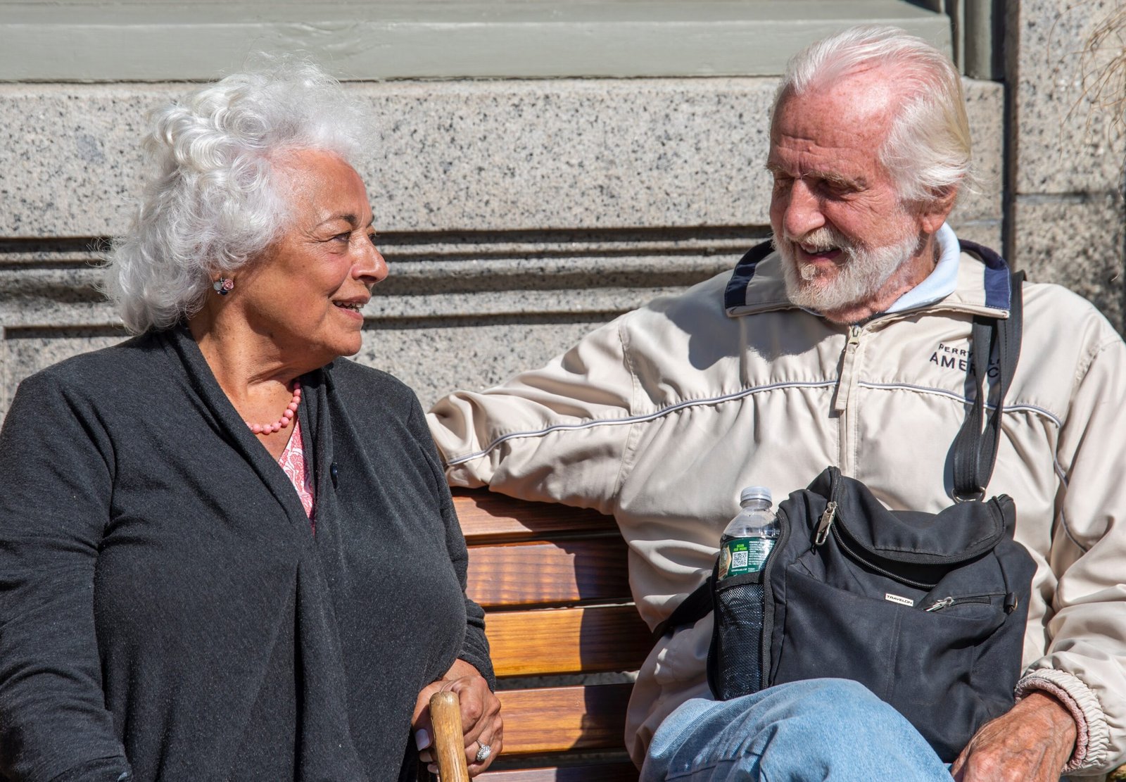 Elderly Black couple seated at a bench in long-term relationships