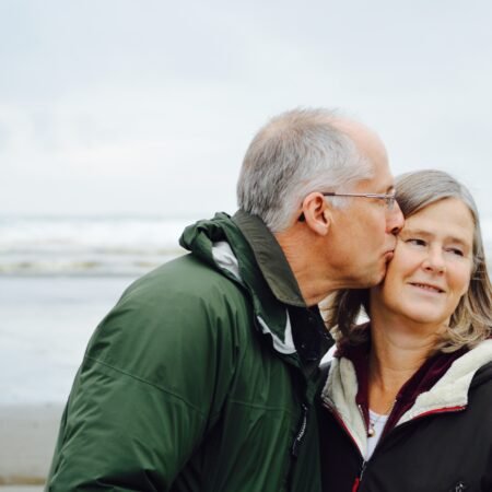 A couple kissing on the beach, one of the signs of a healthy relationship.