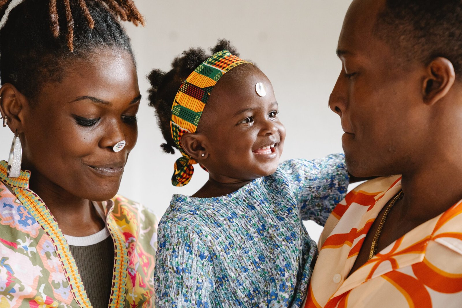 A Black couple with their smiling daughter as a sign of commitment in relationships