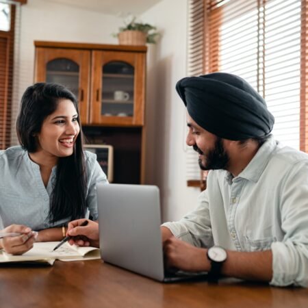 An Indian couple on their dinning table happily engaged in communication in marriage