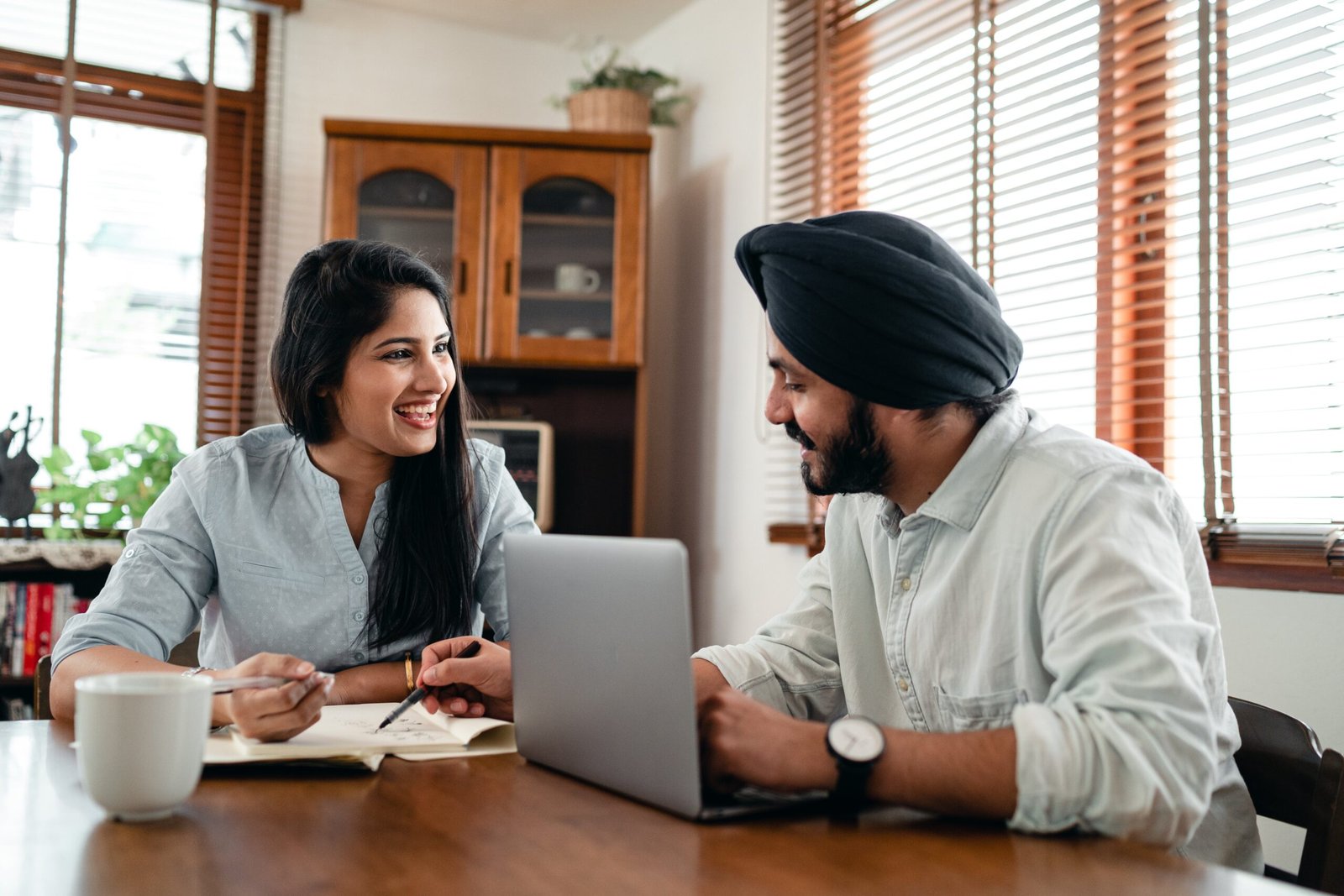 An Indian couple on their dinning table happily engaged in communication in marriage