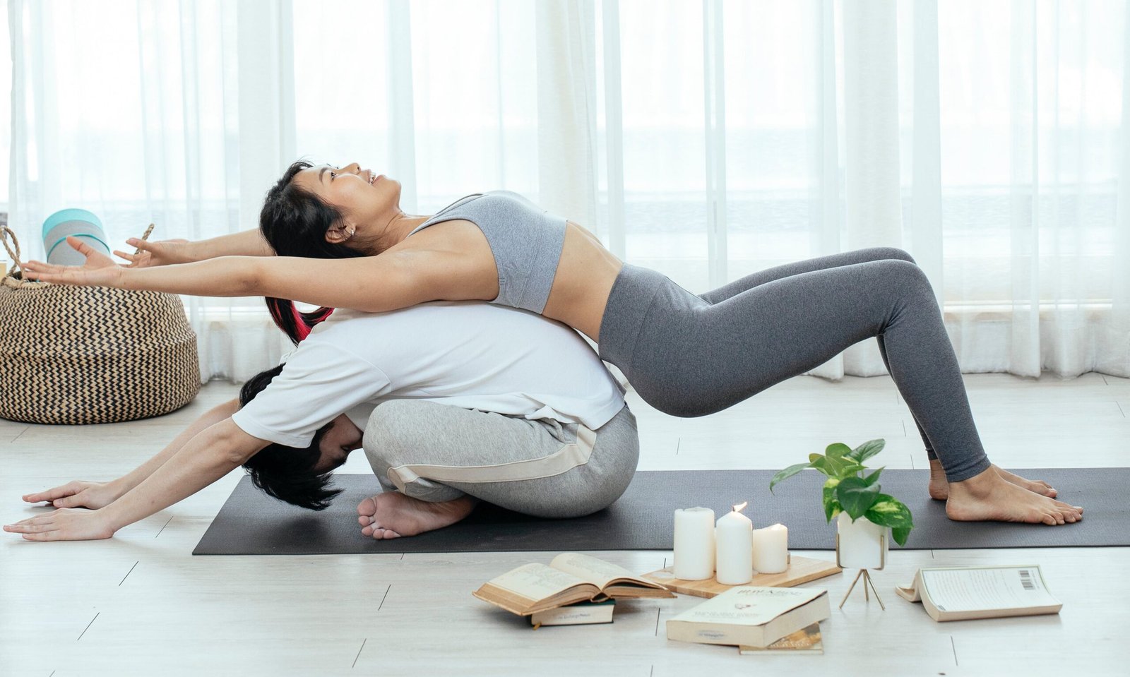 A couple in a peaceful stretch pose illustrating their masculine and feminine energy.