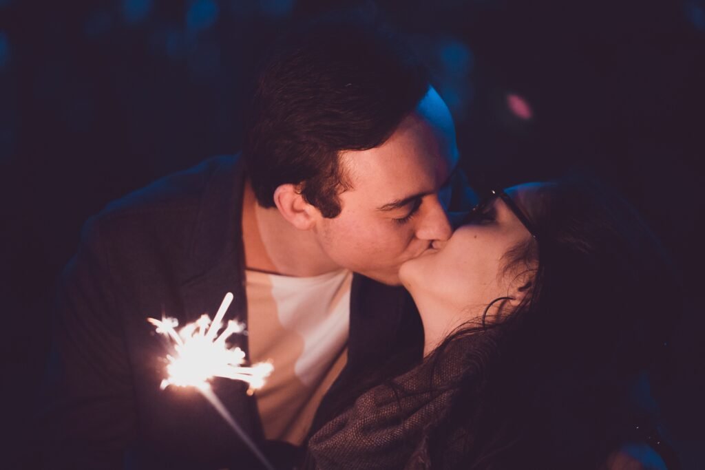 A couple kissing under dazzling light as a sign of their romance in marriage