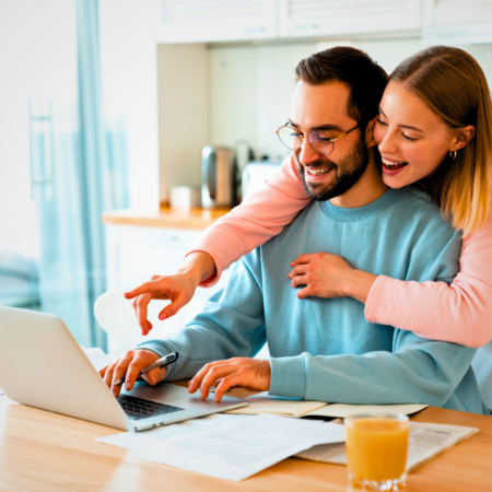 A happy couple enjoying their quality time love language as they make a Zoom call to their daughter in College.