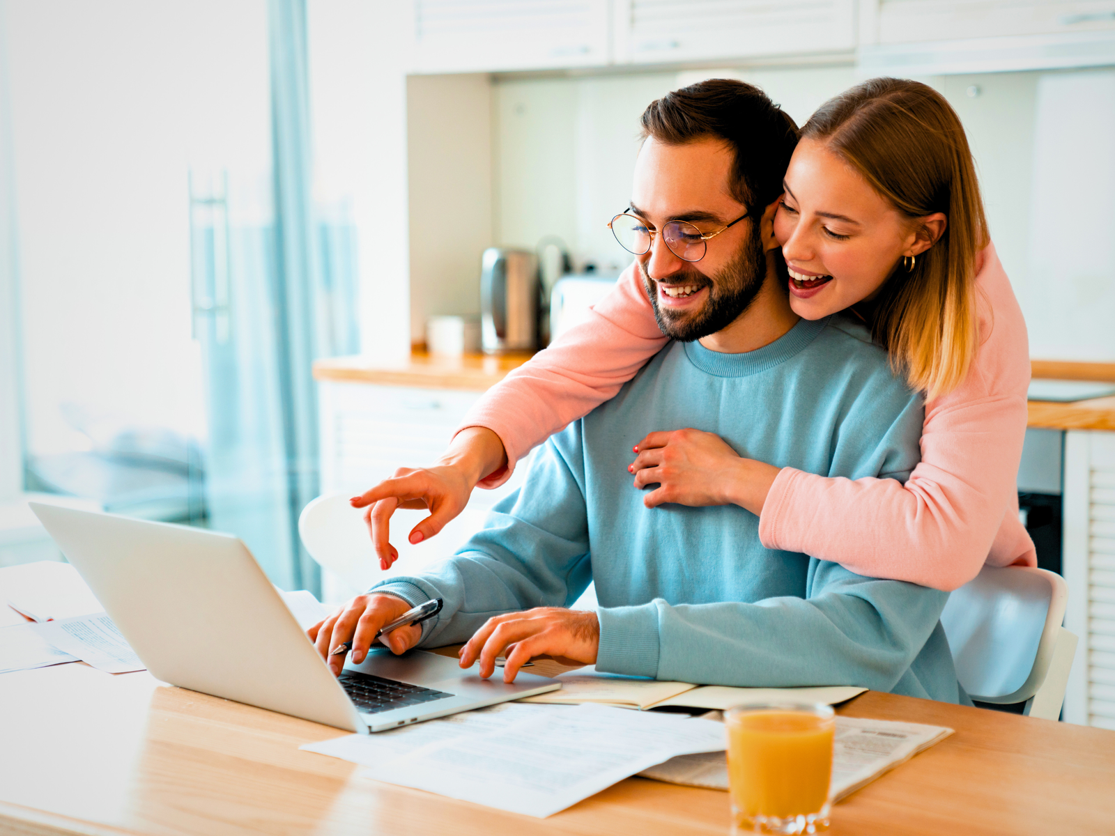 A happy couple enjoying their quality time love language as they make a Zoom call to their daughter in College.