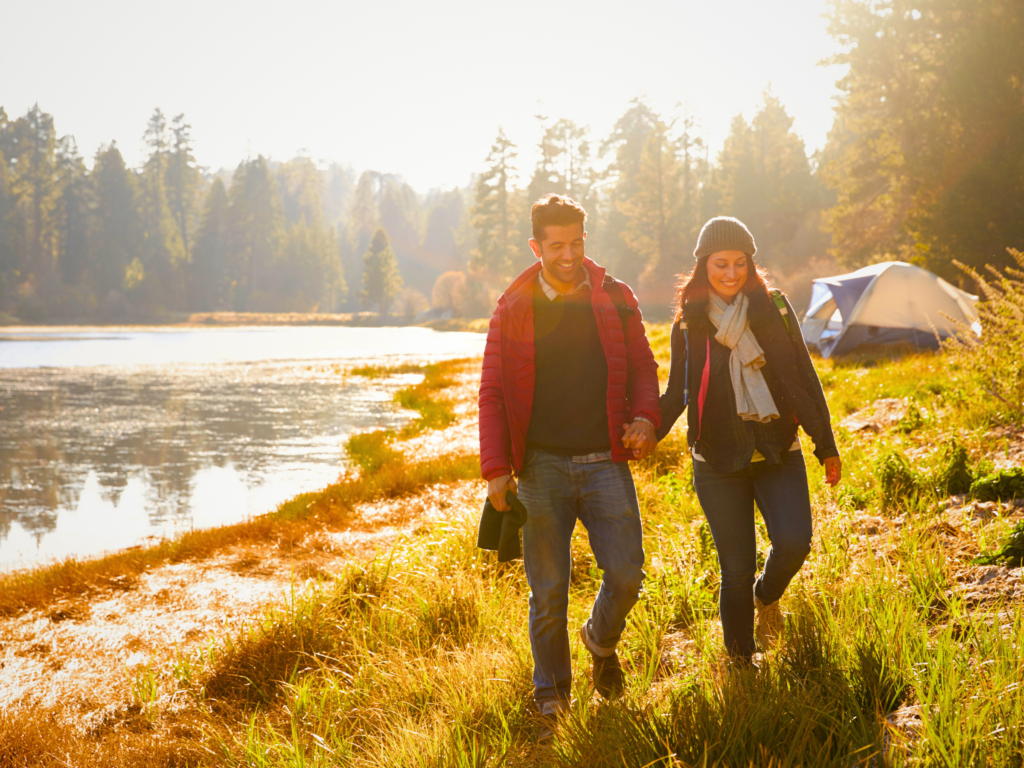 A couple enjoying a quality time as they stroll along the beach on a family hiking outing.