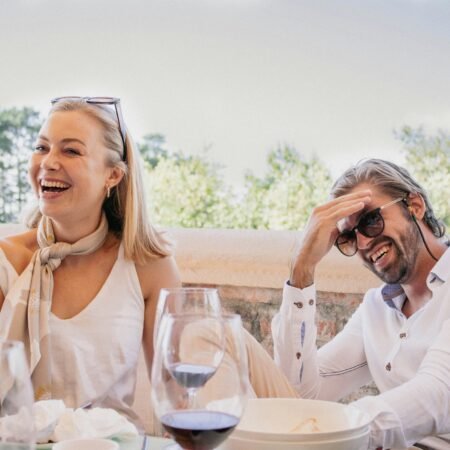 A happy couple laughing after the wife served her husband dinner in line with the 'happy husband happy life' adage.