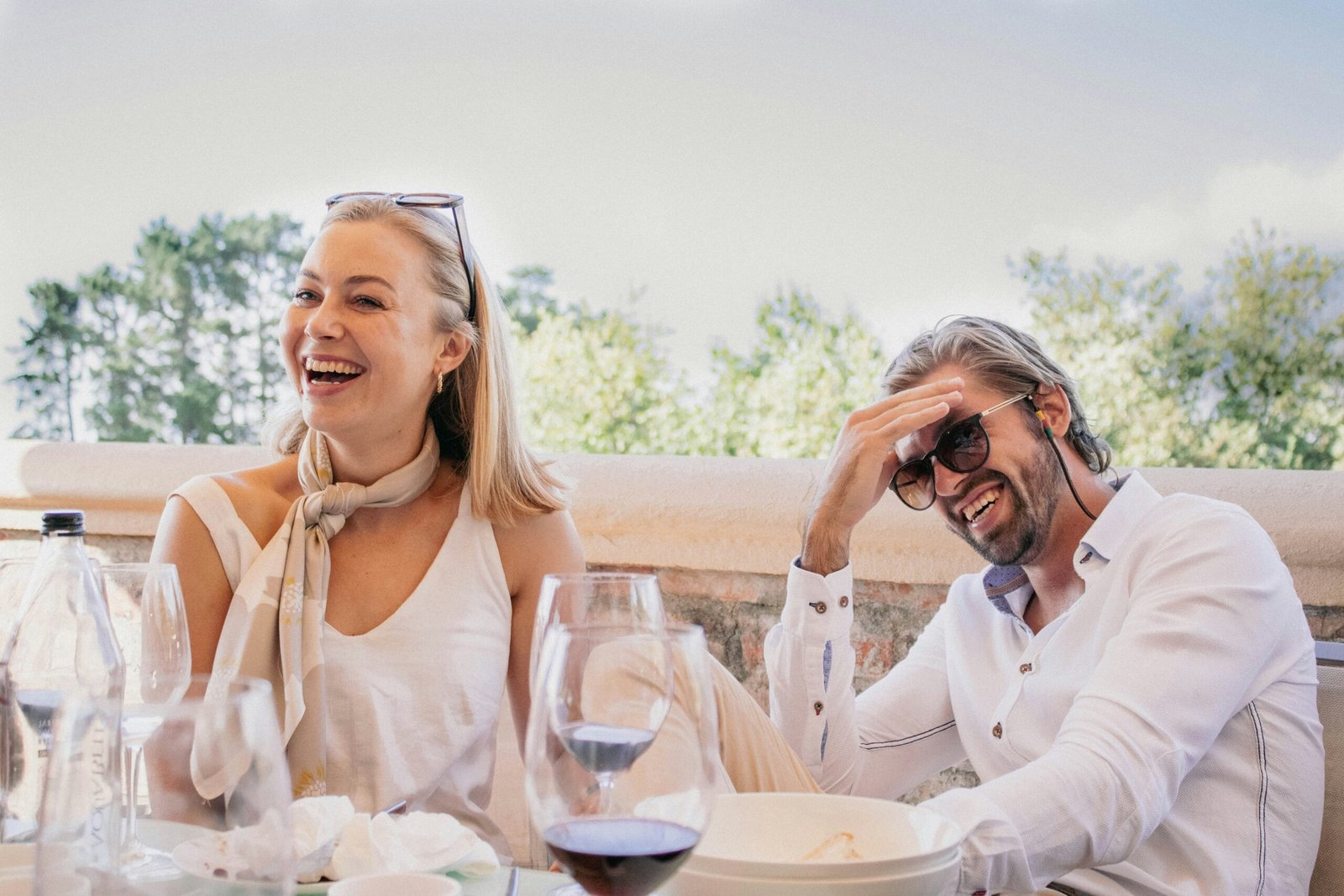 A happy couple laughing after the wife served her husband dinner in line with the 'happy husband happy life' adage.